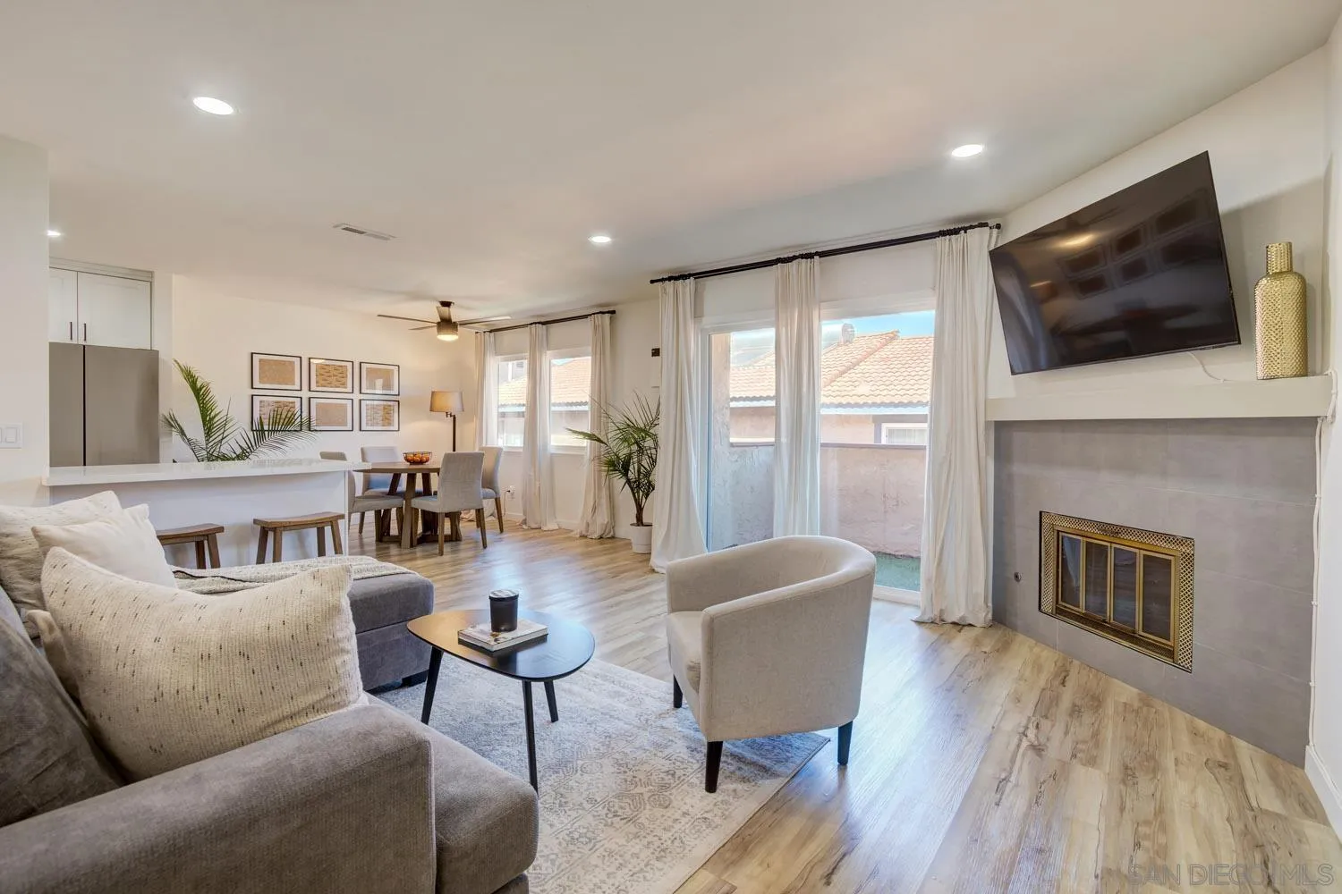 10784 Tamar Terrace, Unit C Santee, CA 92071 - Photo 19 of 33 a living room with furniture a flat screen tv and a fireplace