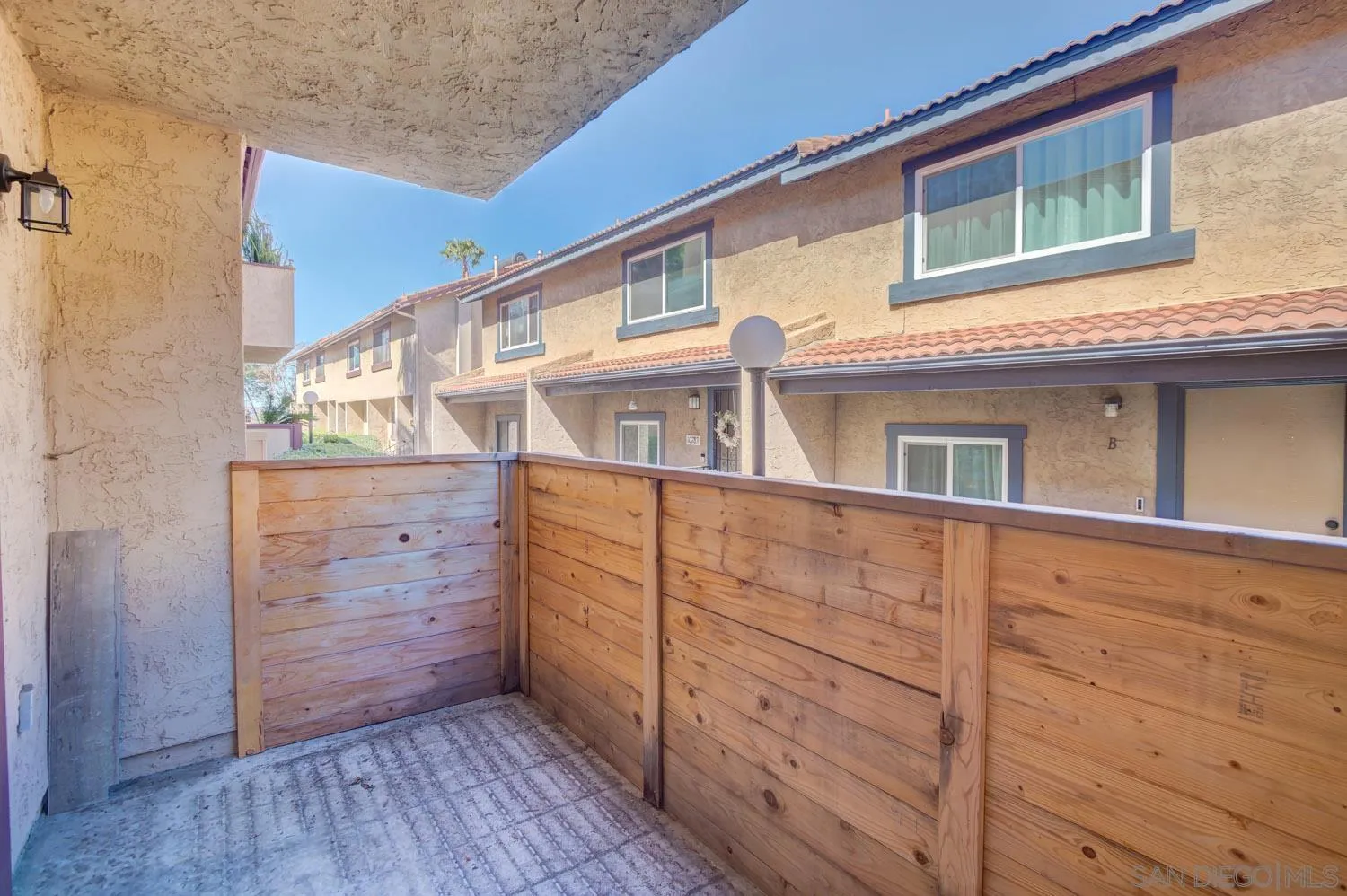 10784 Tamar Terrace, Unit C Santee, CA 92071 - Photo 28 of 33 a view of a house with a wooden fence