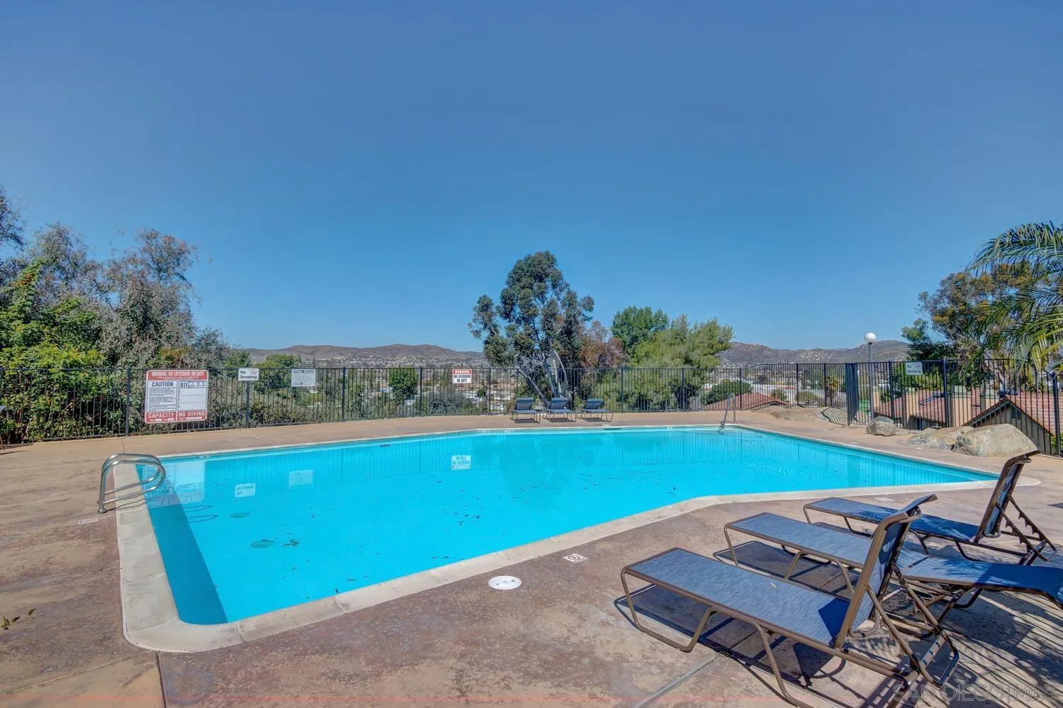 10784 Tamar Terrace, Unit C Santee, CA 92071 - Photo 33 of 33 a view of a backyard with lawn chairs and a fire pit