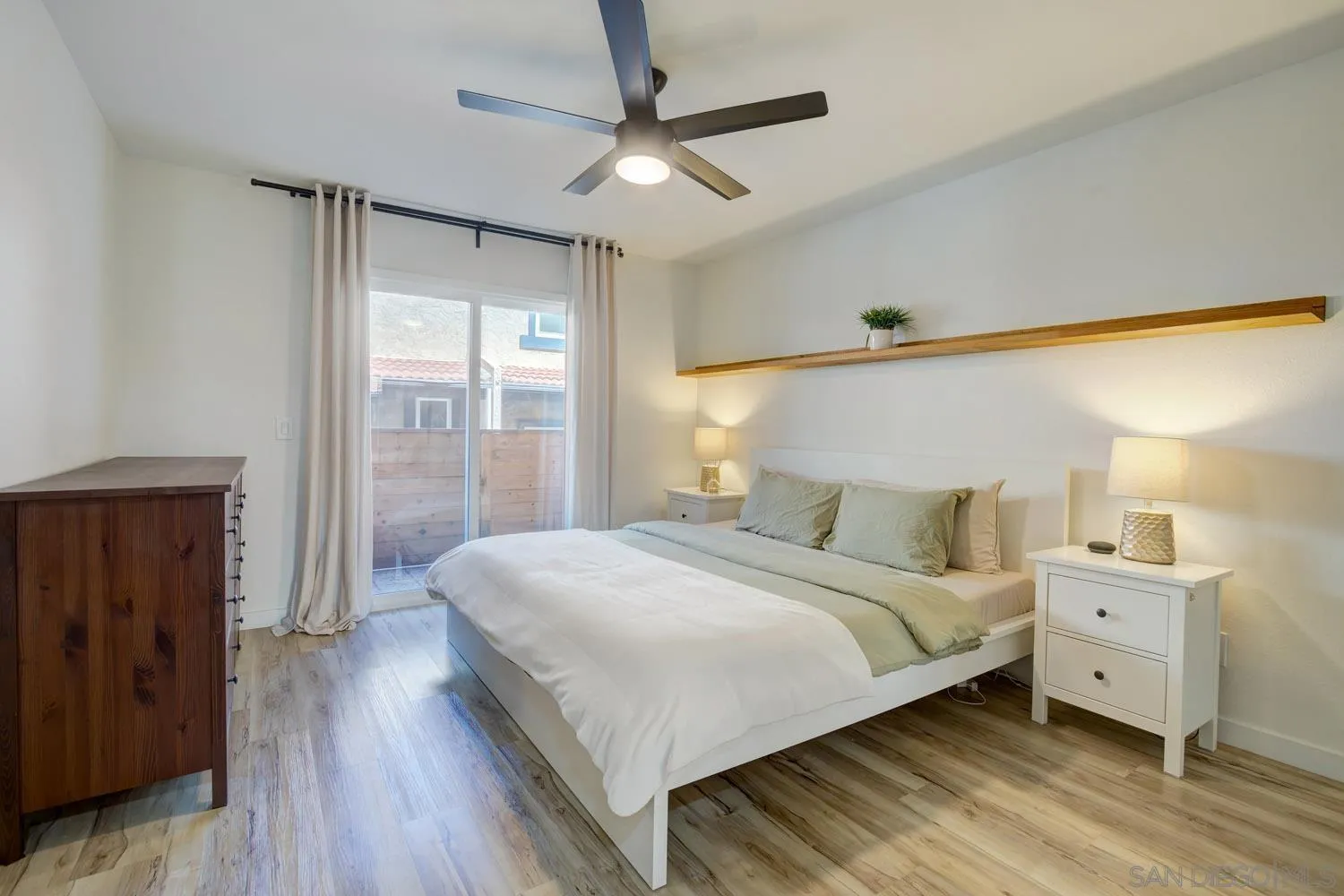 10784 Tamar Terrace, Unit C Santee, CA 92071 - Photo 8 of 33 a bedroom with a large bed and a chandelier