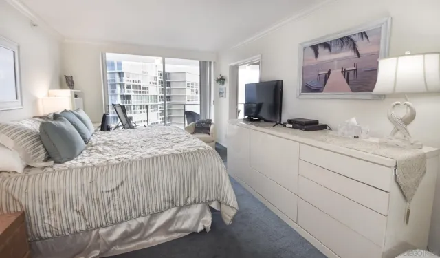 a bedroom with a bed and flat screen tv