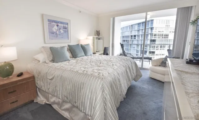 a spacious bedroom with a bed and a large window