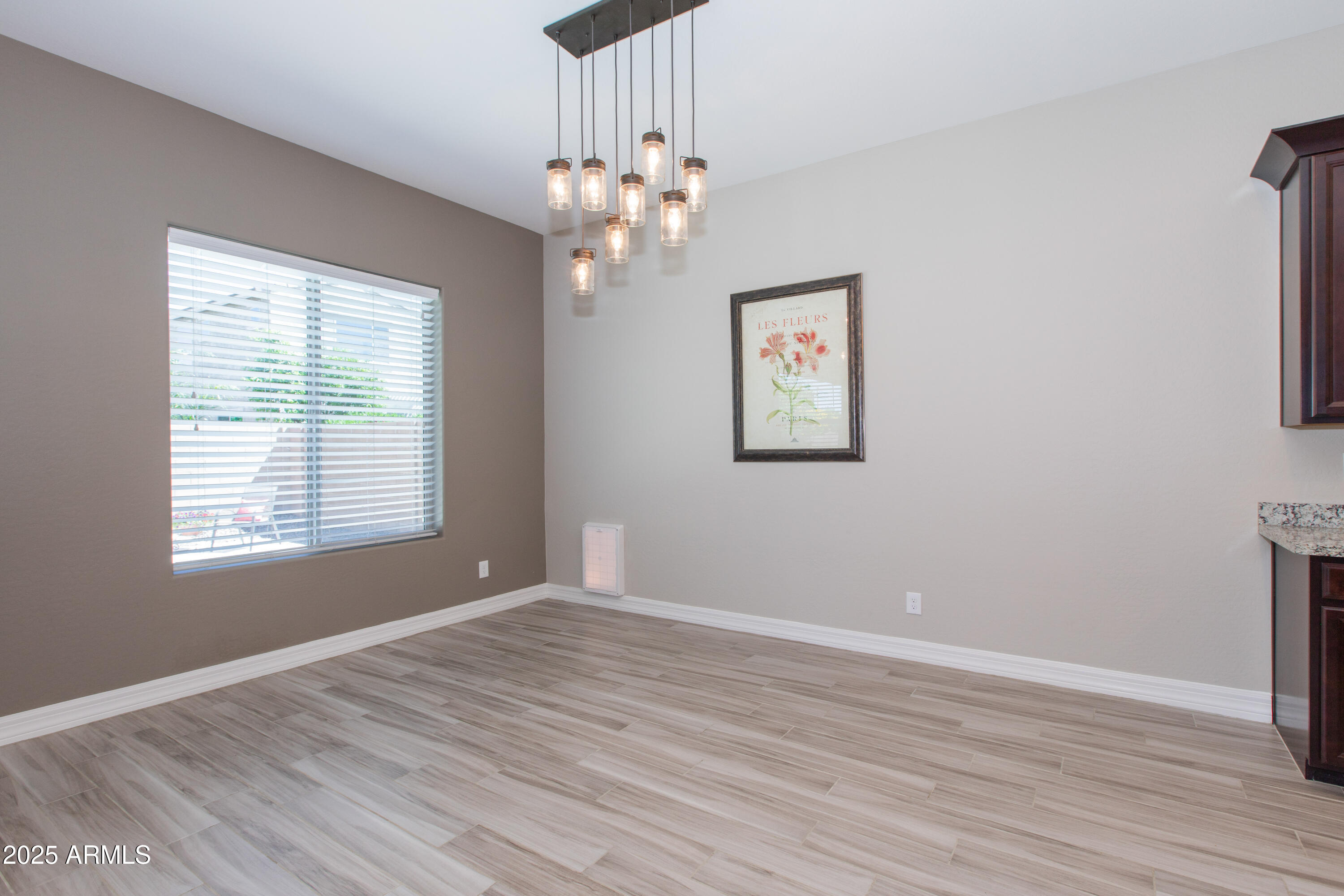20084 Rosa Road Queen Creek, AZ 85142 - Photo 11 of 53 a view of an empty room with wooden floor and a window