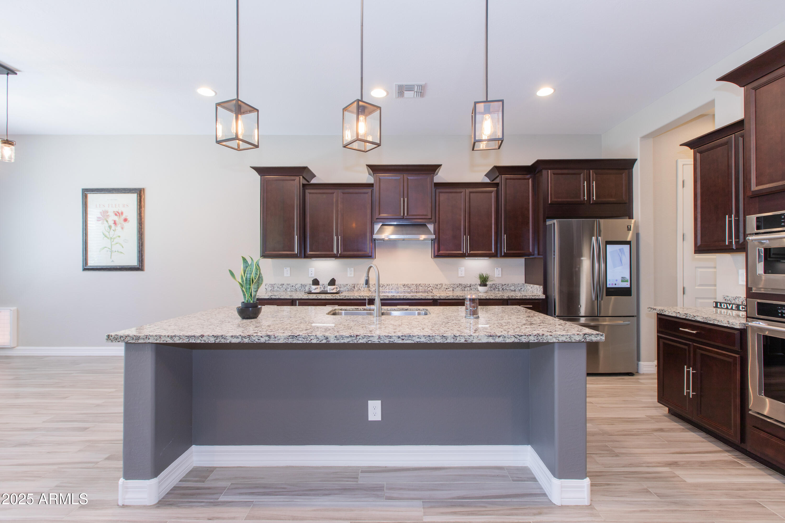 20084 Rosa Road Queen Creek, AZ 85142 - Photo 12 of 53 a large kitchen with granite countertop a large island in the center and stainless steel appliances