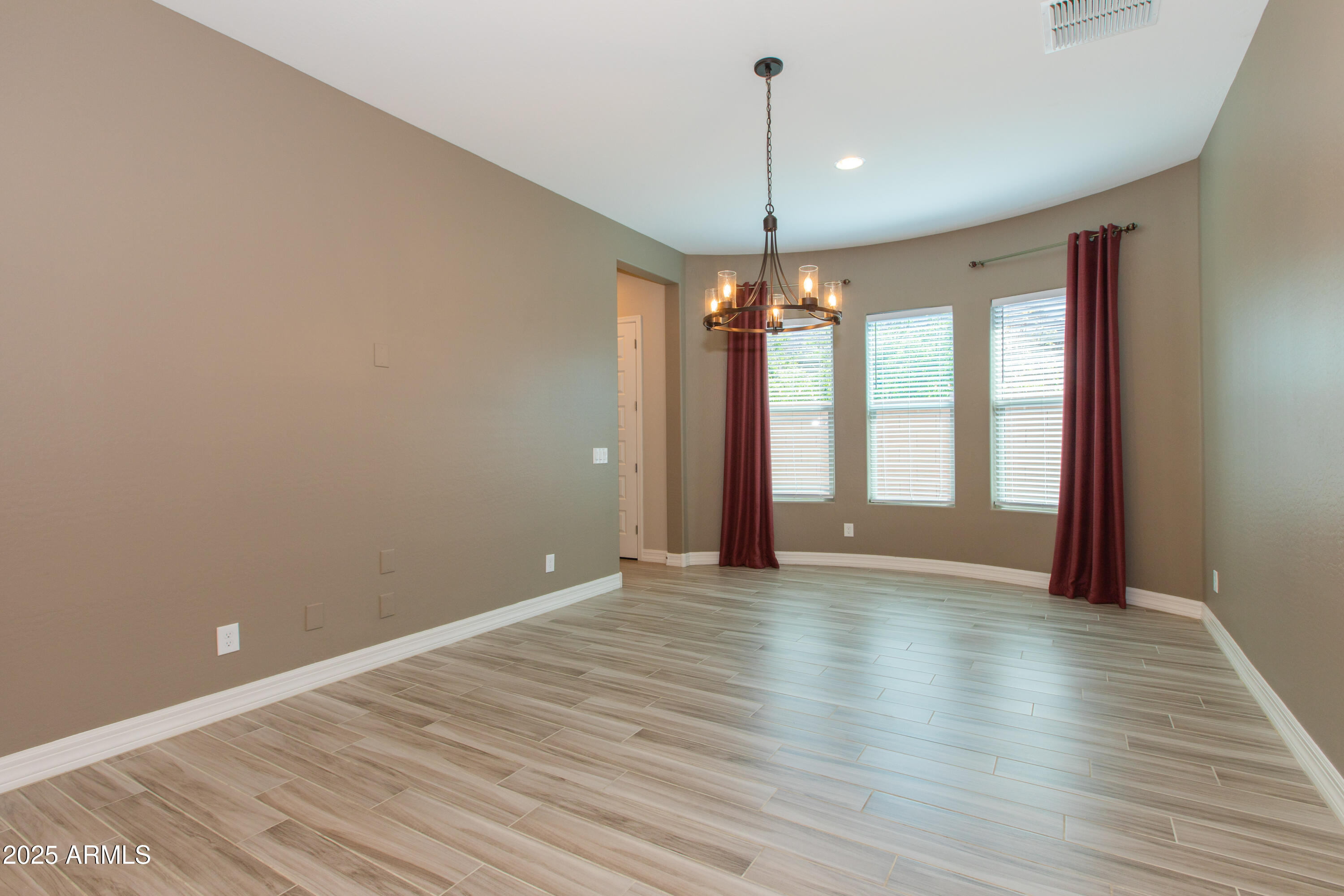 20084 Rosa Road Queen Creek, AZ 85142 - Photo 14 of 53 a view of an empty room with window and wooden floor