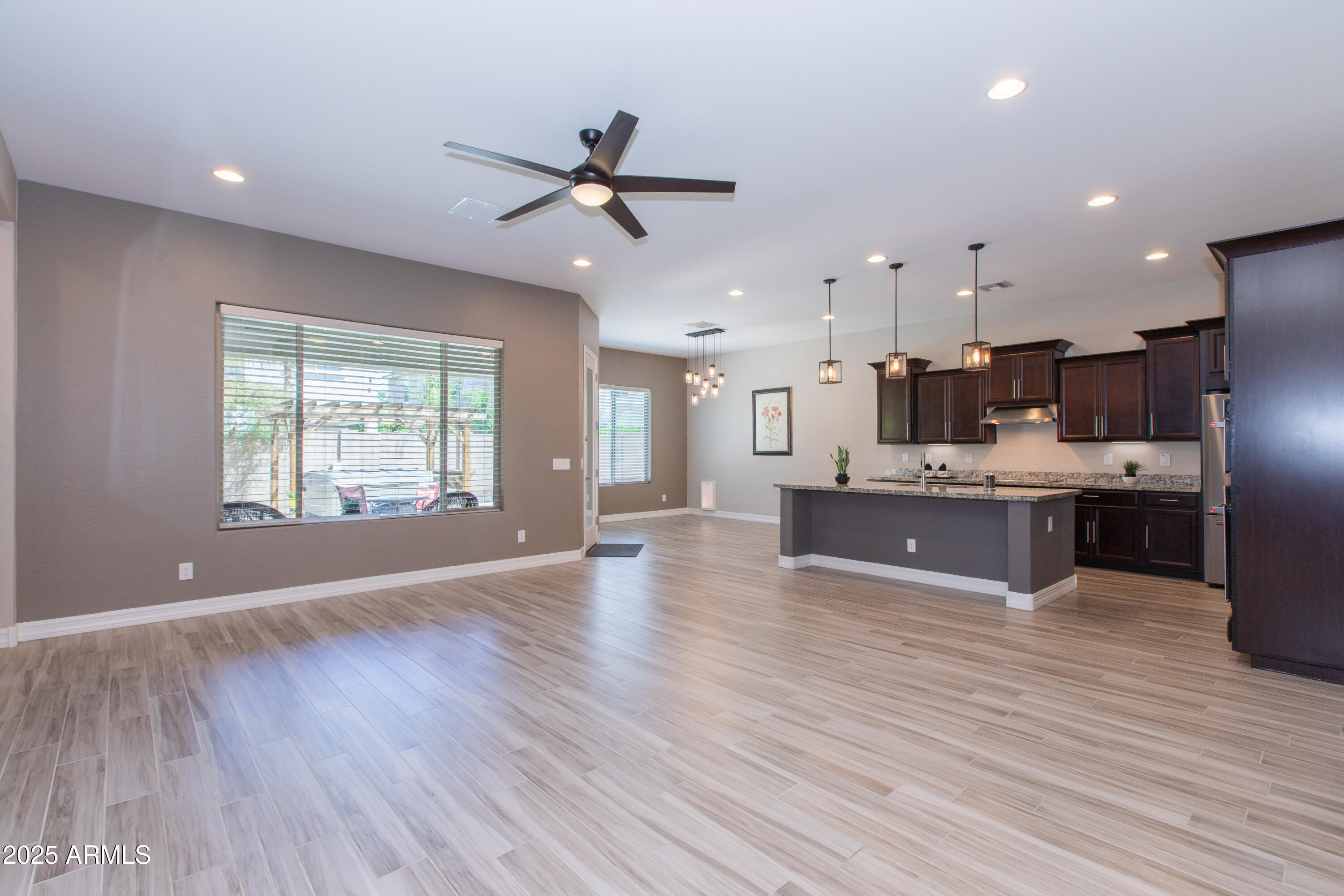 20084 Rosa Road Queen Creek, AZ 85142 - Photo 15 of 53 a large kitchen with stainless steel appliances a large counter top a sink a refrigerator and a window