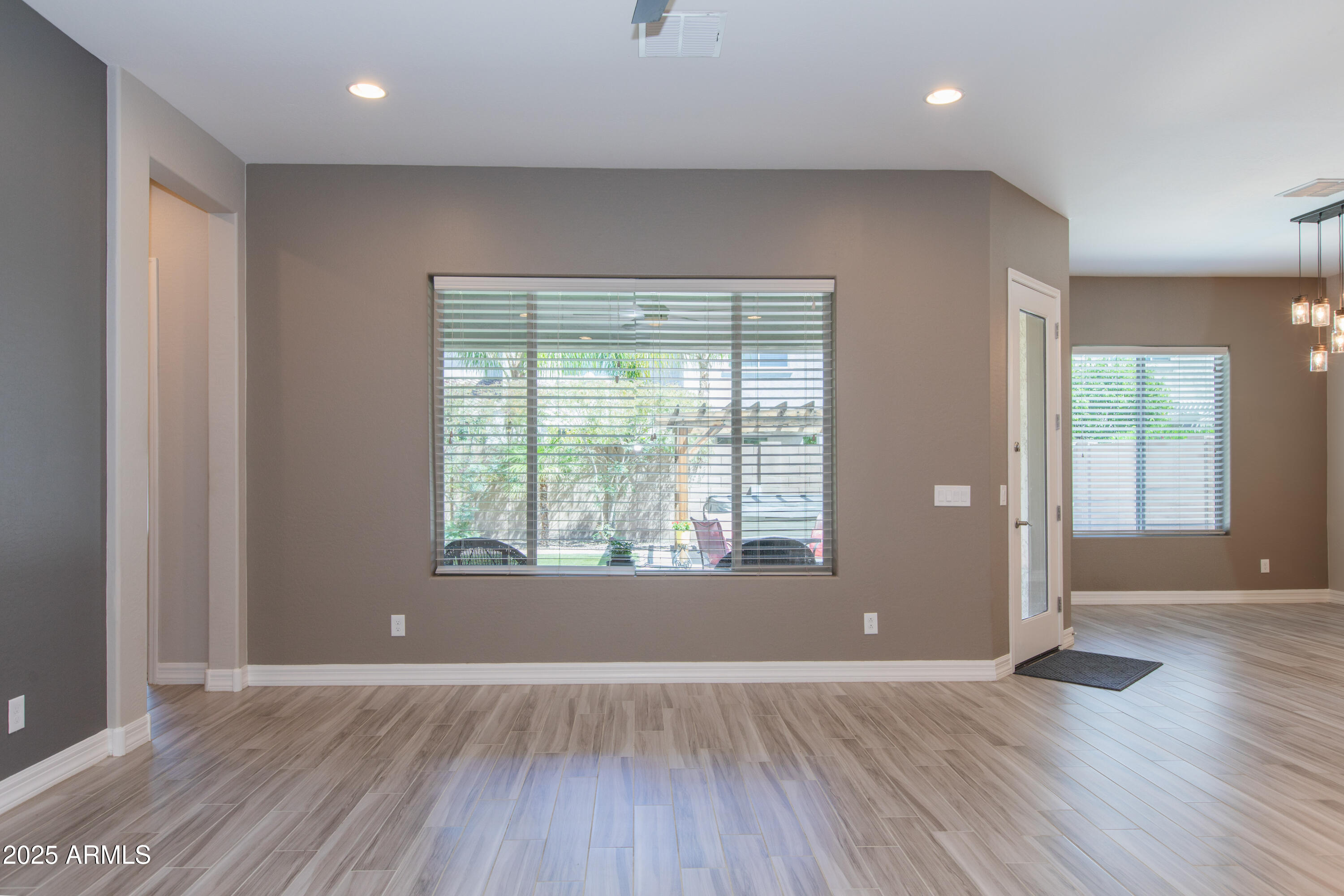 20084 Rosa Road Queen Creek, AZ 85142 - Photo 21 of 53 an empty room with wooden floor and windows
