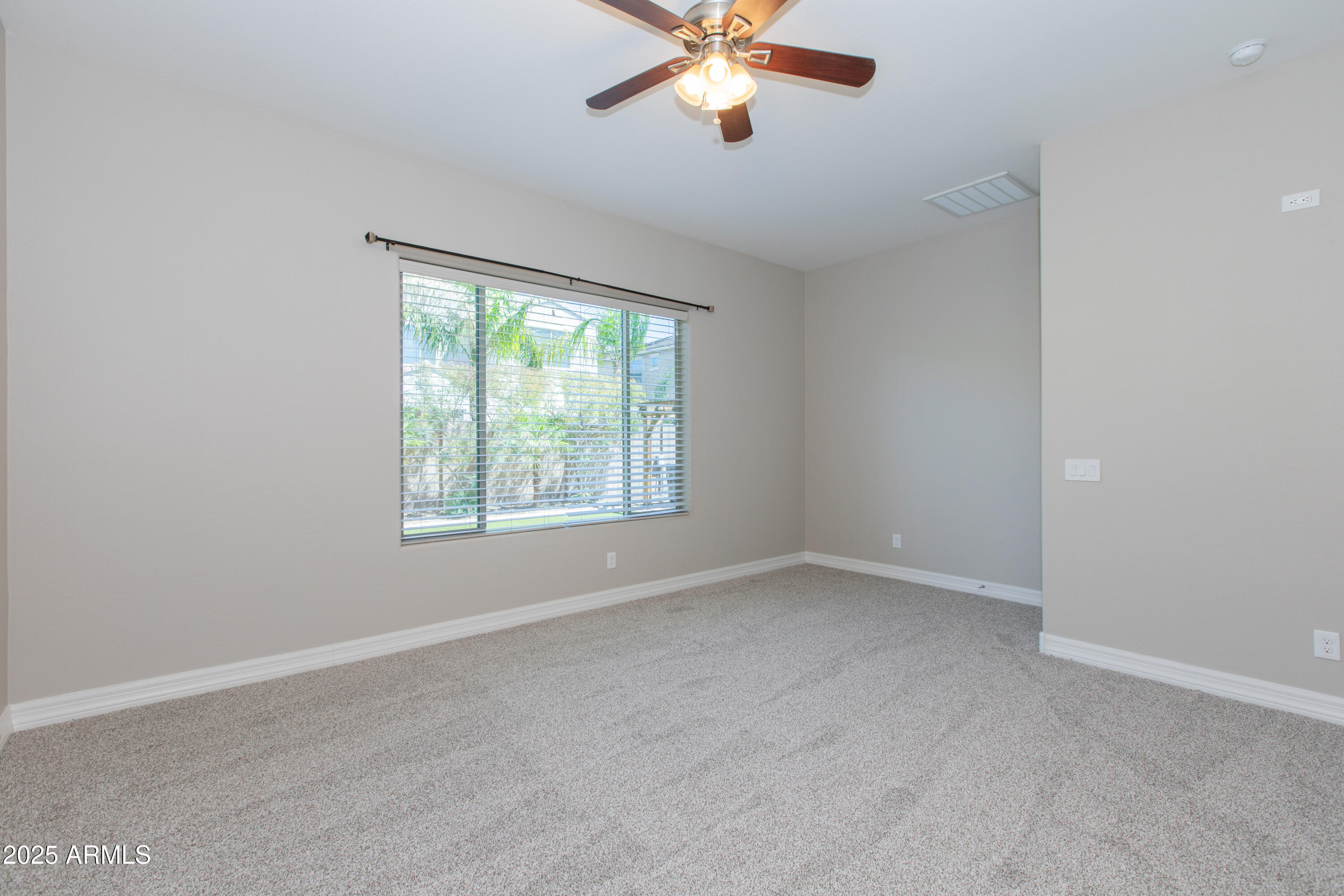 20084 Rosa Road Queen Creek, AZ 85142 - Photo 24 of 53 an empty room with a window and a fan