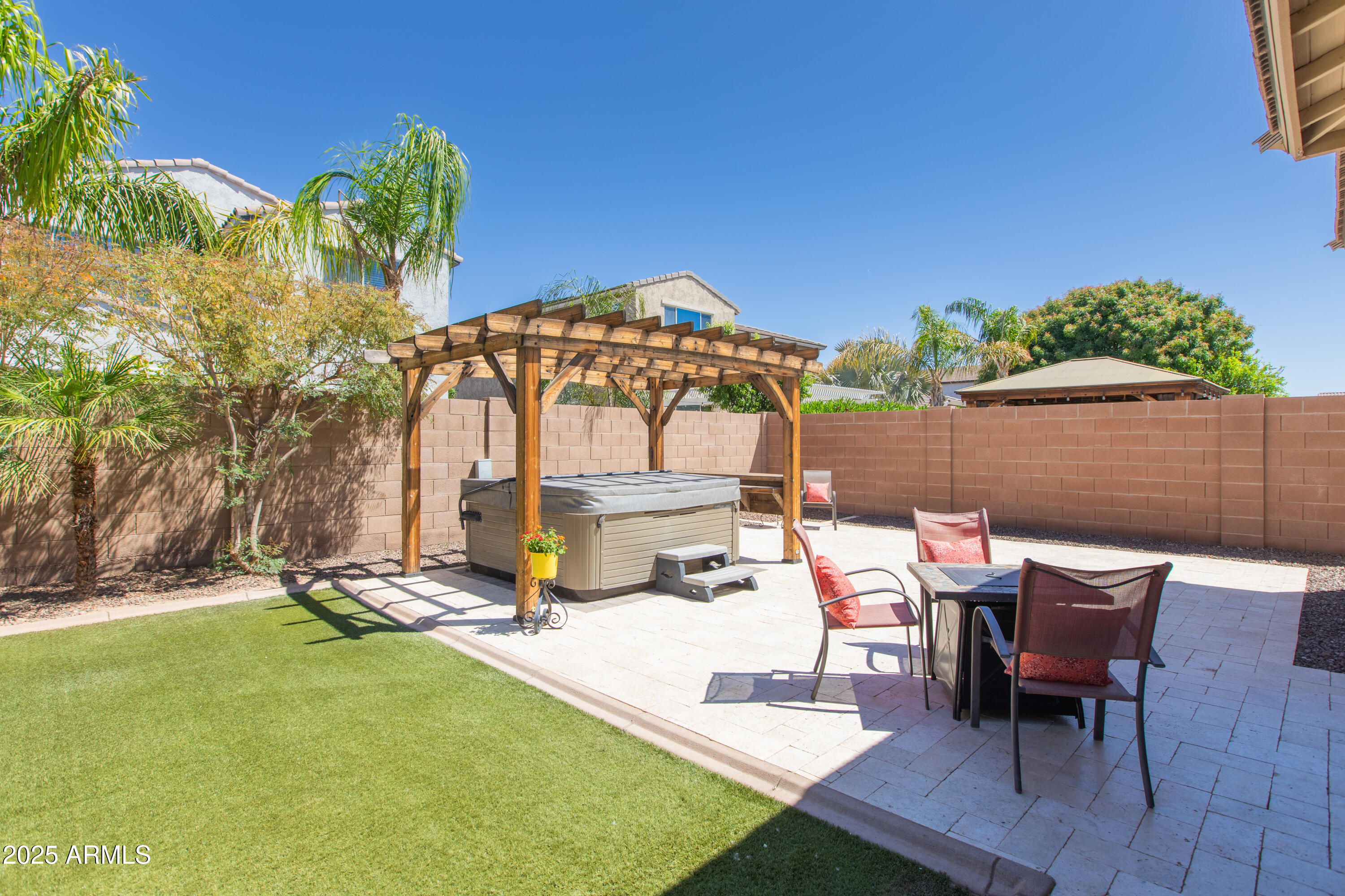 20084 Rosa Road Queen Creek, AZ 85142 - Photo 43 of 53 a view of a patio with table and chairs under an umbrella