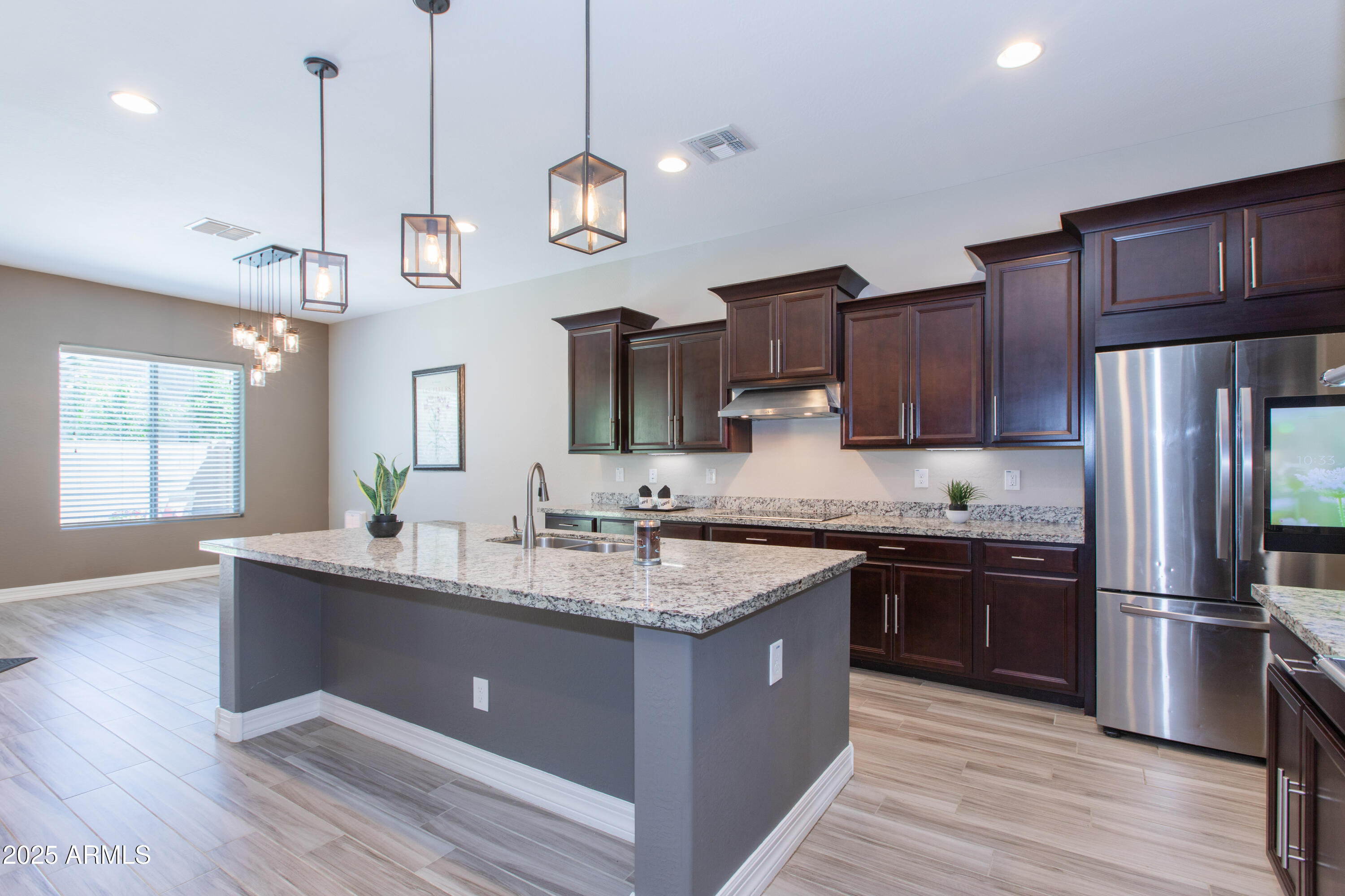 20084 Rosa Road Queen Creek, AZ 85142 - Photo 8 of 53 a large kitchen with stainless steel appliances granite countertop a sink a stove and a wooden floors
