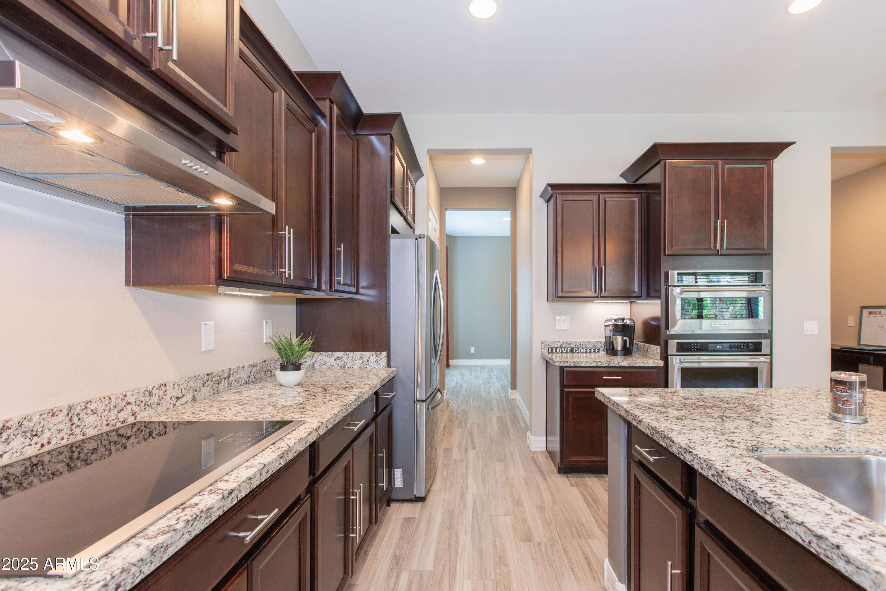 20084 Rosa Road Queen Creek, AZ 85142 - Photo 9 of 53 a kitchen with granite countertop kitchen island stainless steel appliances a sink stove and cabinets