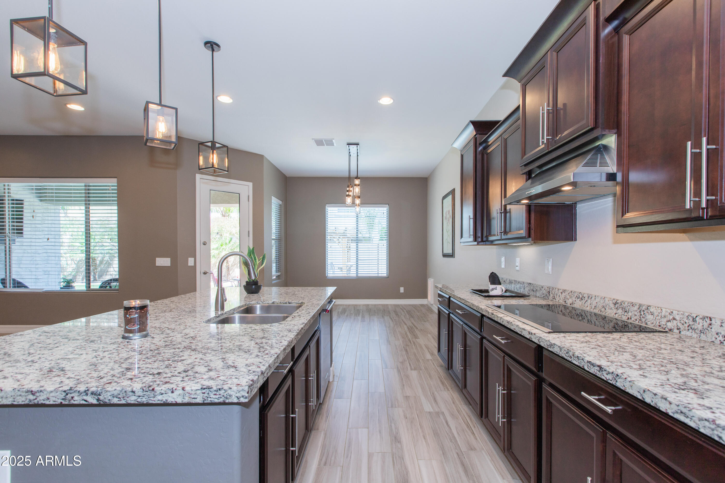 20084 Rosa Road Queen Creek, AZ 85142 - Photo 10 of 53 a kitchen with stainless steel appliances granite countertop a sink stove and cabinets
