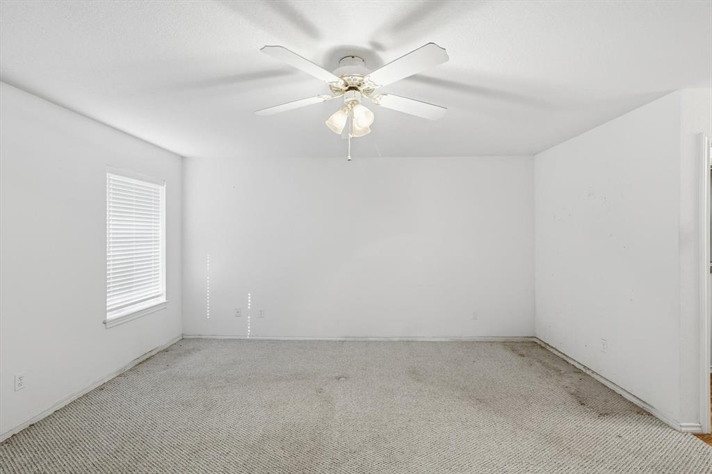 11320 Willow Springs Road Haslet, TX 76052 - Photo 11 of 28 an empty room with windows and fan