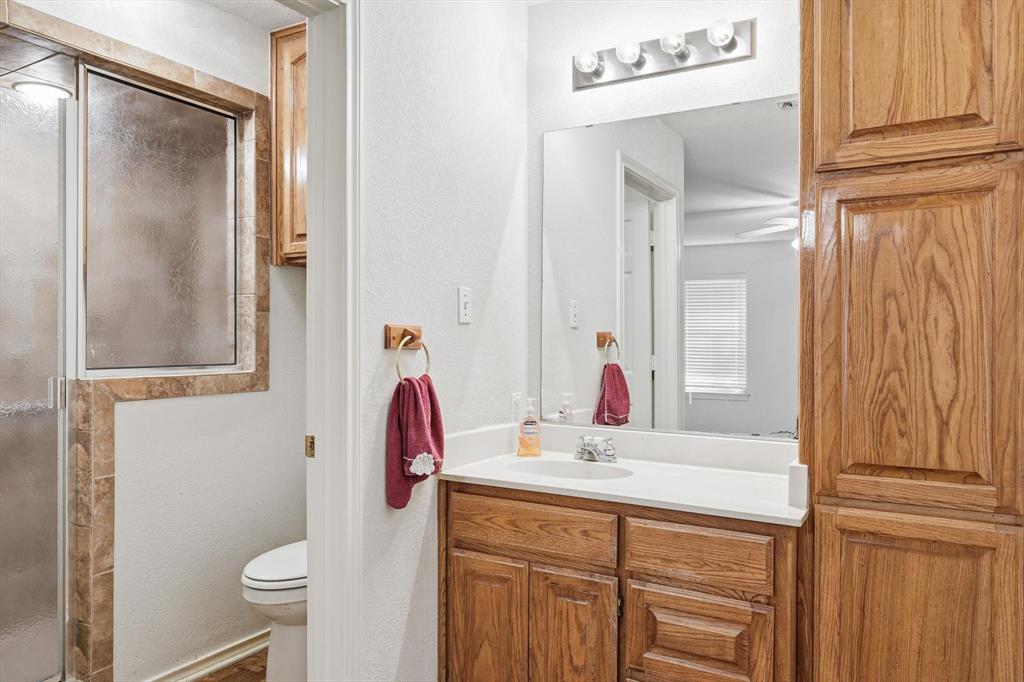 11320 Willow Springs Road Haslet, TX 76052 - Photo 13 of 28 a bathroom with a sink vanity mirror and toilet