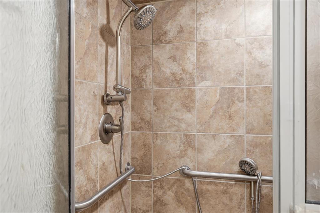 11320 Willow Springs Road Haslet, TX 76052 - Photo 14 of 28 a bathroom with a glass shower door