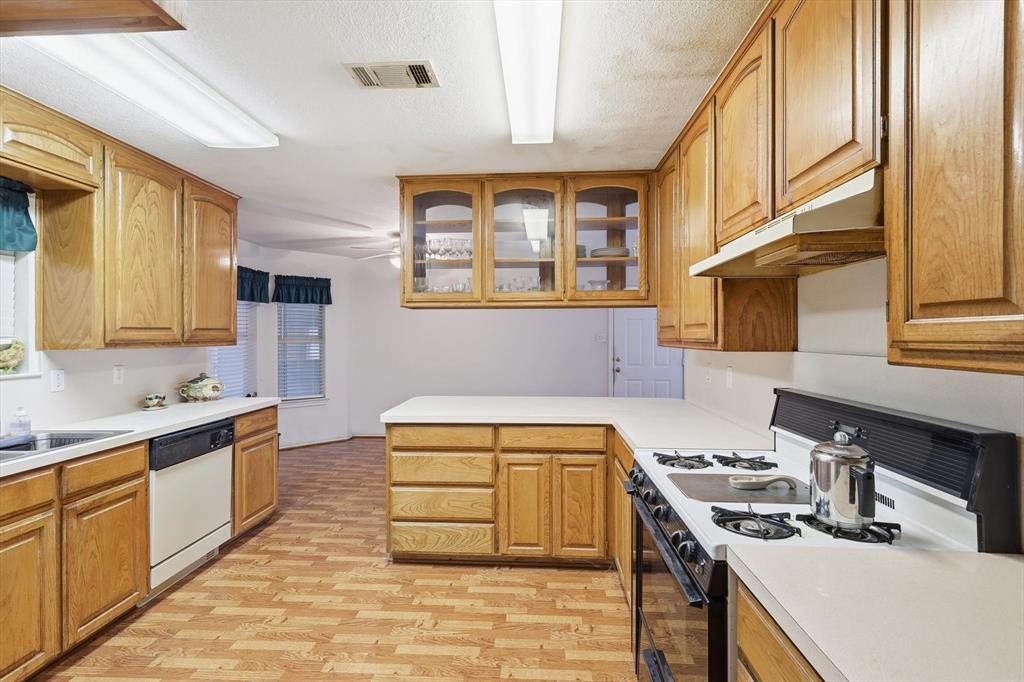 11320 Willow Springs Road Haslet, TX 76052 - Photo 7 of 28 a kitchen that has a sink and a stove in it