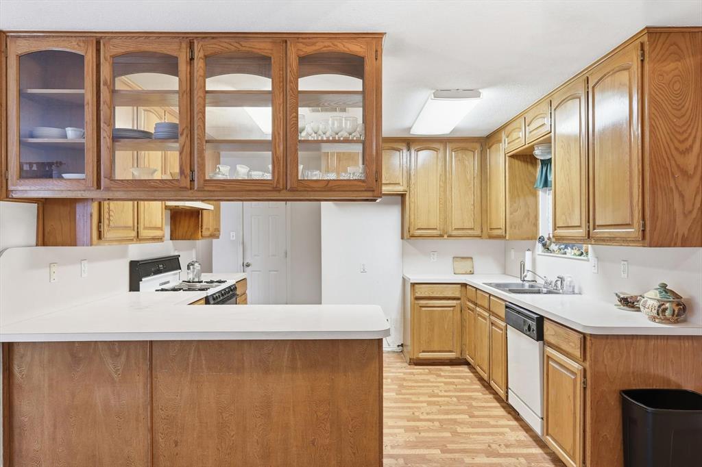 11320 Willow Springs Road Haslet, TX 76052 - Photo 8 of 28 a kitchen with a sink stove and cabinets