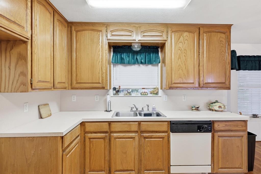 11320 Willow Springs Road Haslet, TX 76052 - Photo 9 of 28 a kitchen with stainless steel appliances granite countertop a sink and cabinets