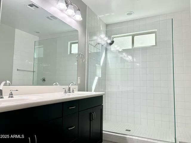 a bathroom with a sink double vanity and a mirror