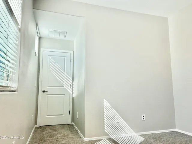 a view of a room with wooden floor and a window