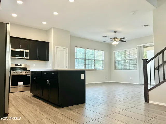 a view of a living room kitchen and a flat screen tv