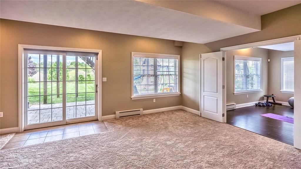 167 Pinkerton Road Wexford, PA 15090 - Photo 20 of 25 The finished game room with sliding glass door to the yard and patio features new carpeting and freshly painted walls.
