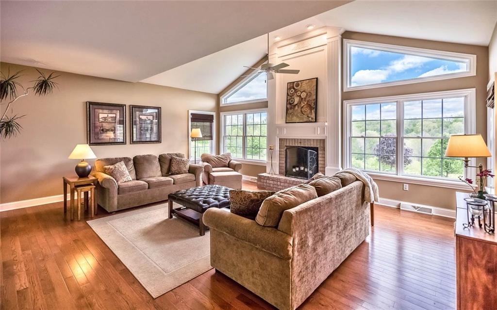 167 Pinkerton Road Wexford, PA 15090 - Photo 9 of 25 A lovely fireplace, bookcases and wall of windows create an inviting atmosphere in the cathedral family room.