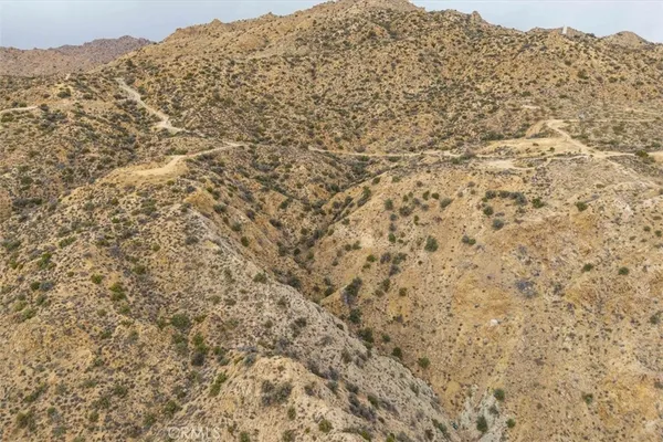 a view of a mountain range in a cloudy sky