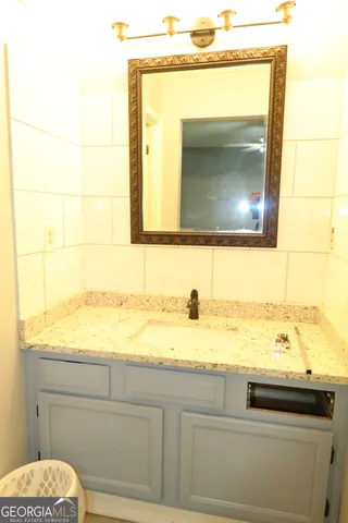 a bathroom with a sink a mirror and a toilet