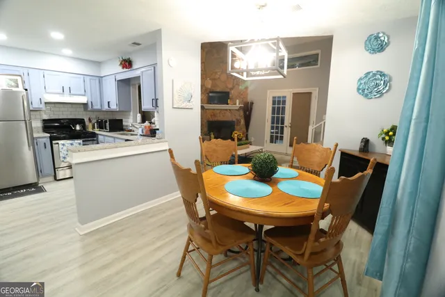 a view of a dining room with furniture and a kitchen