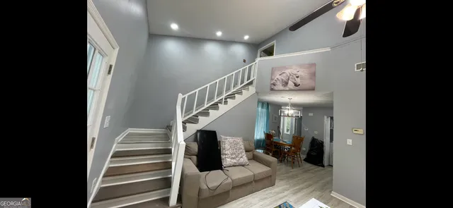 a view of entryway and hall with wooden floor