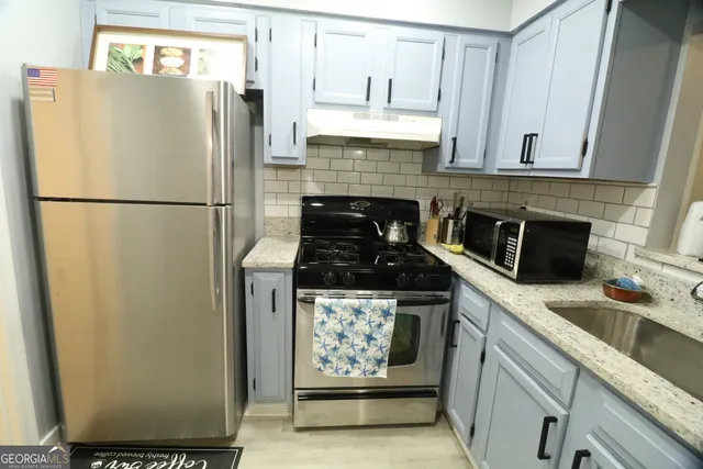 a kitchen with appliances and cabinets