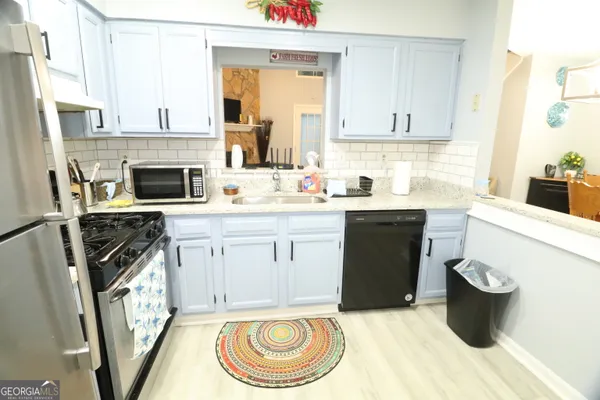 a kitchen with a stove a sink and a refrigerator