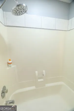 a bathroom with a granite countertop sink and a toilet