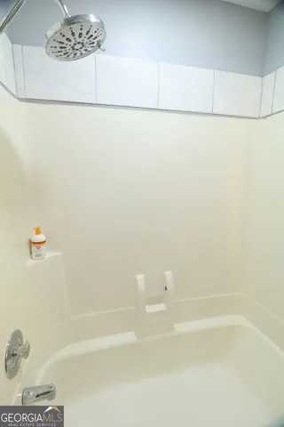 a bathroom with a granite countertop sink and a toilet