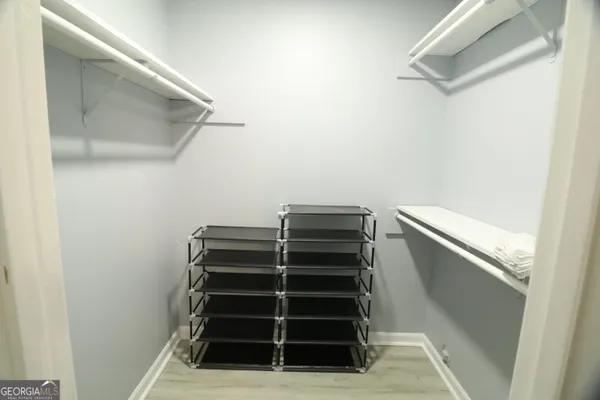 a bedroom with a bed closet and mirror