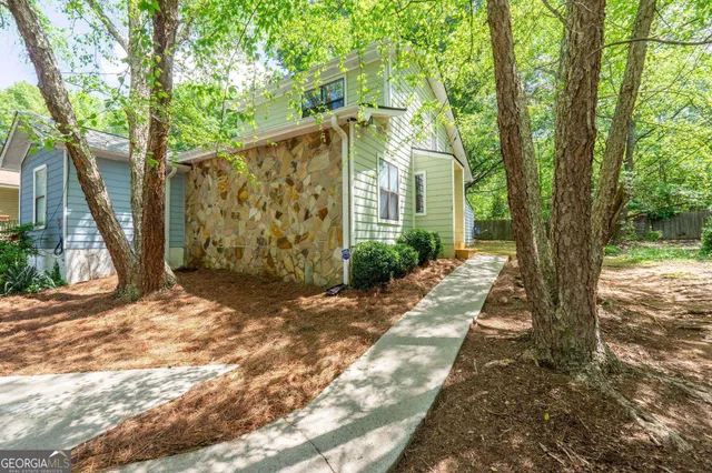a view of a house with a tree in front