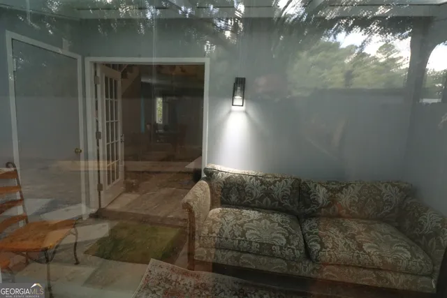 a living room with furniture and a glass door