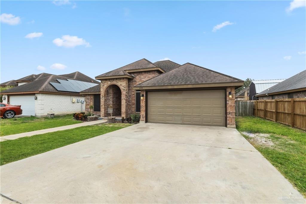 1720 East 2nd Street Weslaco, TX 78596 - Photo 3 of 17 a front view of a house with a yard and garage