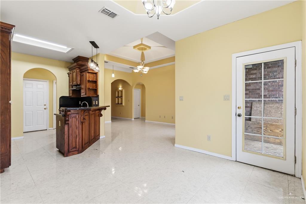 1720 East 2nd Street Weslaco, TX 78596 - Photo 6 of 17 a view of a big room with wooden floor a cabinet and mirrors