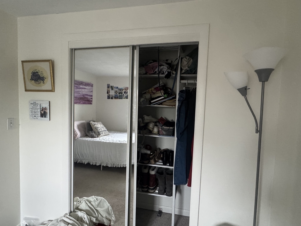 22 Bryon Road, Unit 3 Boston, MA 02467 - Photo 11 of 16 a bedroom with a bed and a closet