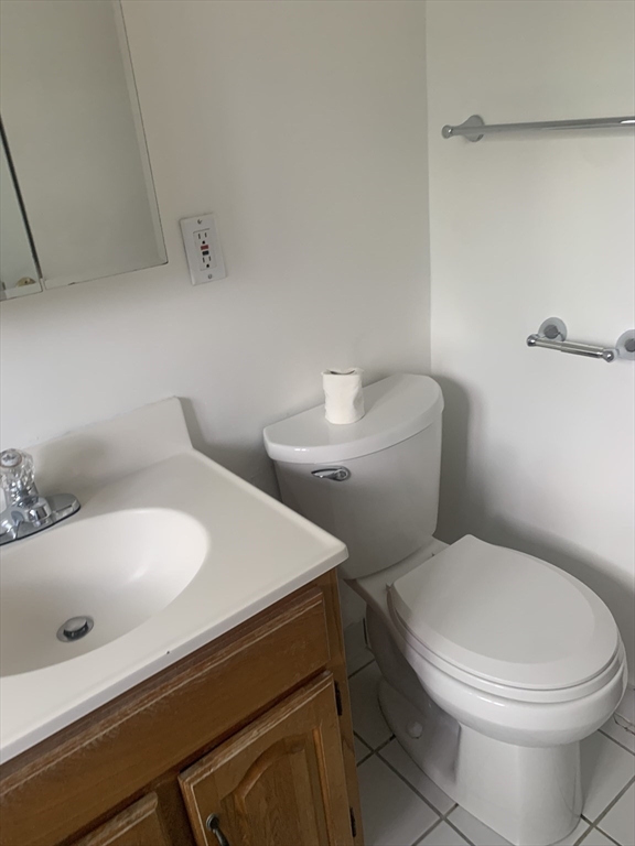 22 Bryon Road, Unit 3 Boston, MA 02467 - Photo 13 of 16 a white toilet sitting next to a bathroom sink