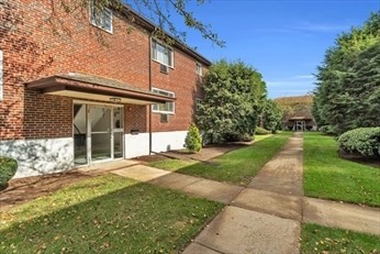 22 Bryon Road, Unit 3 Boston, MA 02467 - Photo 2 of 16 a front view of a house with a yard