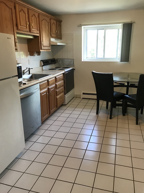 22 Bryon Road, Unit 3 Boston, MA 02467 - Photo 3 of 16 a kitchen with a sink a stove cabinets and counter space