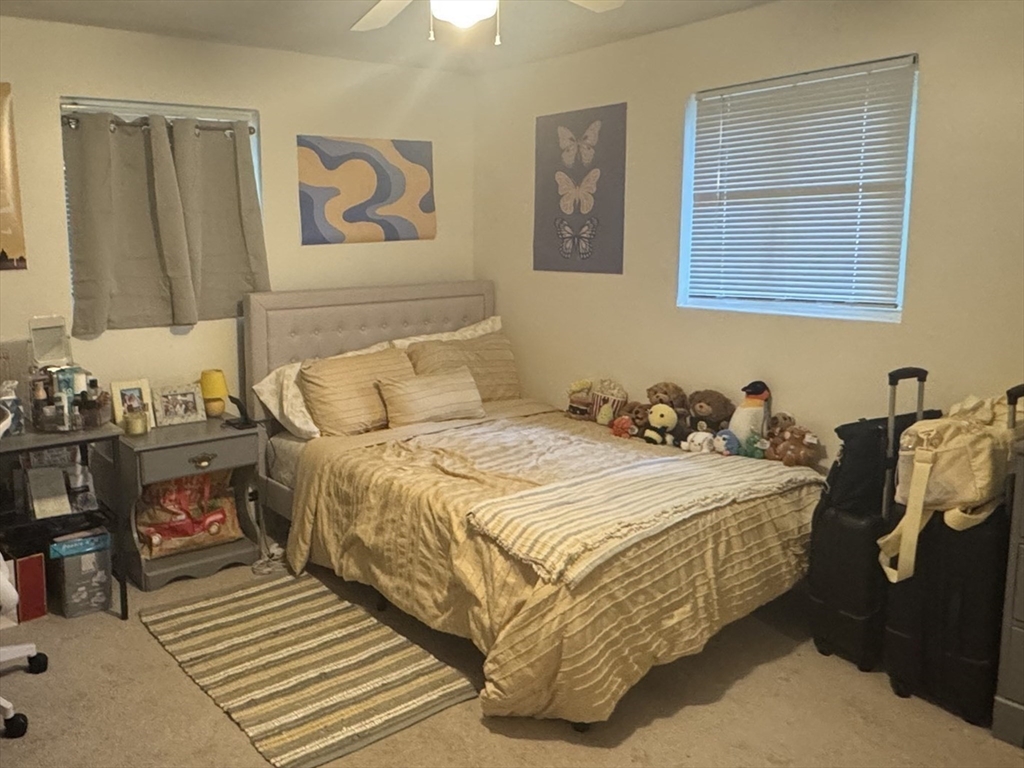 22 Bryon Road, Unit 3 Boston, MA 02467 - Photo 9 of 16 a bedroom with bed and night stand