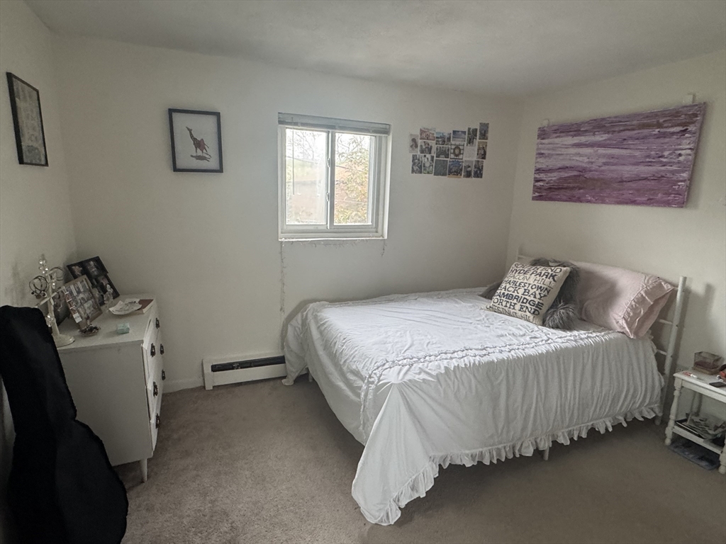 22 Bryon Road, Unit 3 Boston, MA 02467 - Photo 10 of 16 a bedroom with a bed and a window