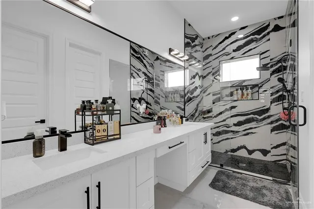 a bedroom with a bed a flat screen tv and a couch