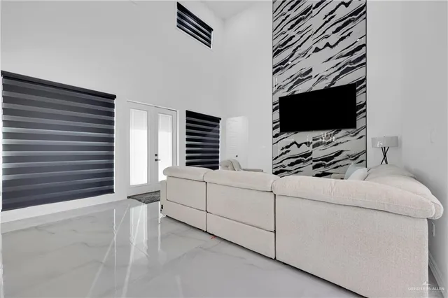 a kitchen with stainless steel appliances kitchen island granite countertop a sink a stove a refrigerator and island with wooden floor