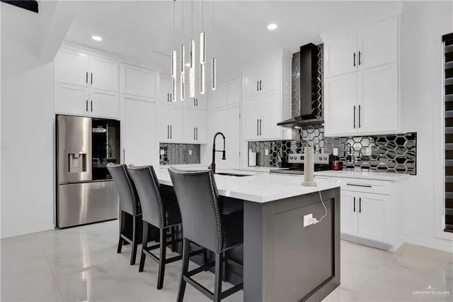 a kitchen with kitchen island a sink stove and white cabinets