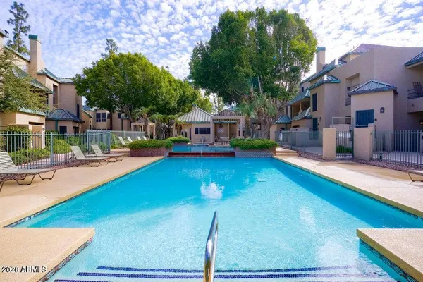a swimming pool with outdoor seating and yard